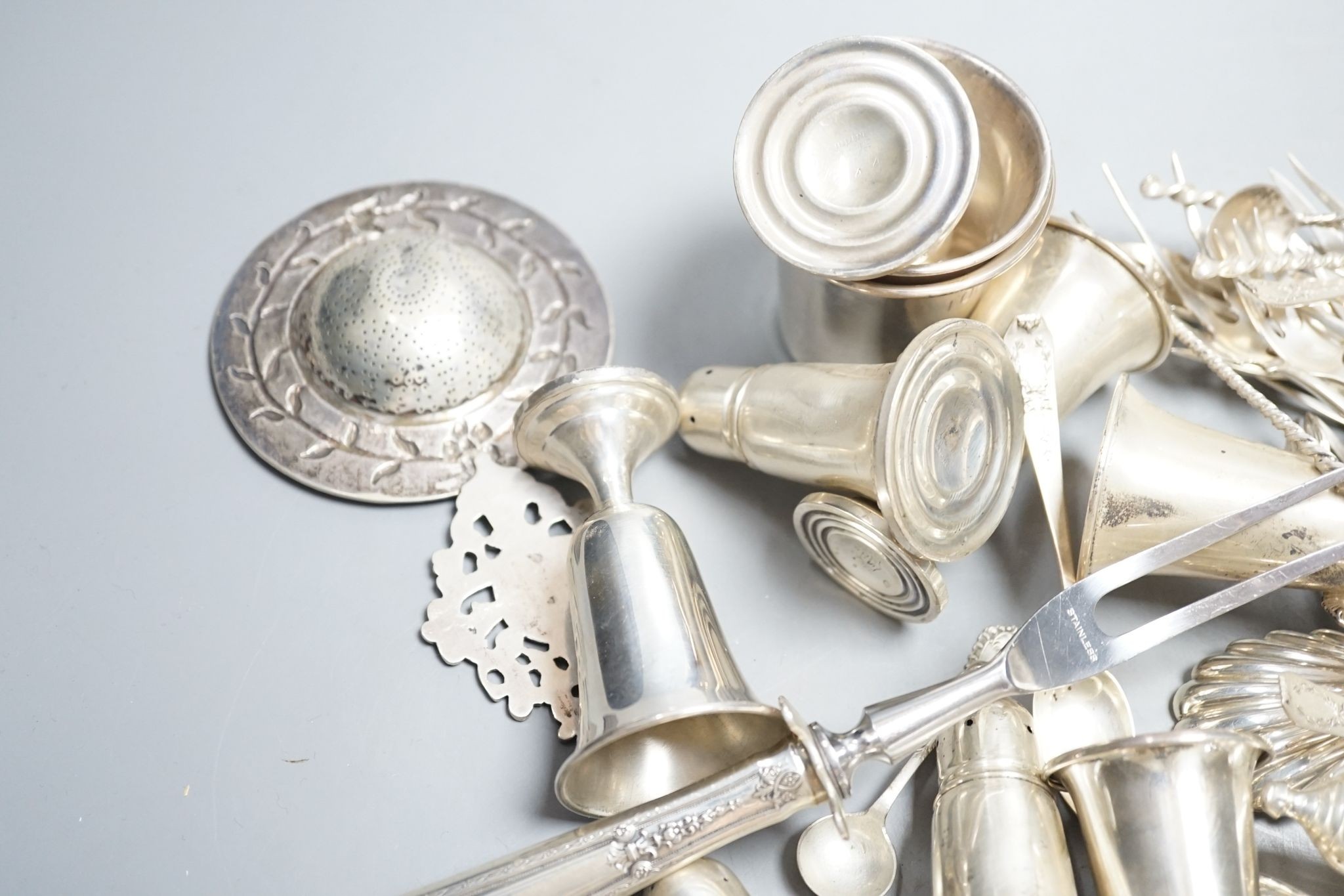 A quantity of American sterling items including four beakers, twelve assorted small goblets(weighted?), six assorted condiments(weighted?) and group of miscellaneous flatware